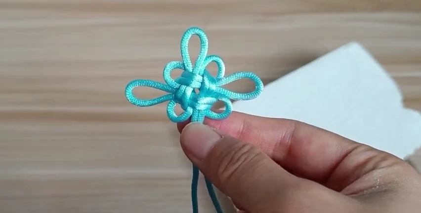 Four-Loop Good Luck Knot demonstrated with real cord